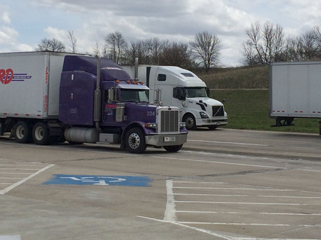 Semi-trucks parked at a rest stop along Interstate 35W. How will current proposed rulemaking of new truck regulations be affected by the White House regulatory freeze released on Jan. 20 and the Jan.30 executive order reducing regulations? (DTN photo by Mary Kennedy)